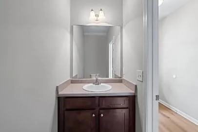 a bathroom with a sink a toilet a mirror and shower