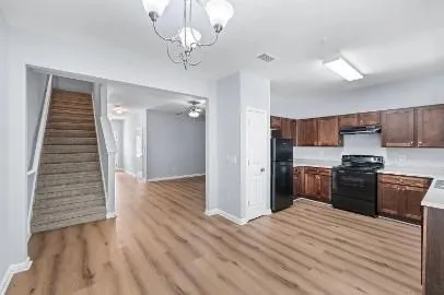 a kitchen with stainless steel appliances granite countertop a refrigerator and a stove top oven