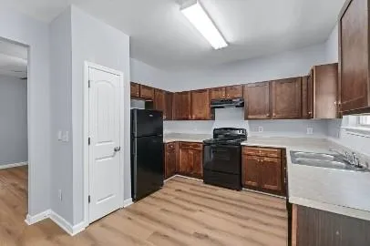 a kitchen with stainless steel appliances granite countertop a refrigerator stove and sink