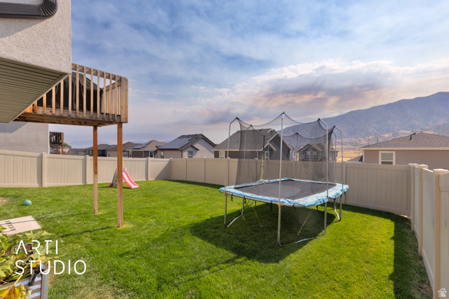 1713 South Windemere Road Santaquin, UT 84655 - Photo 29 of 40 Expansive backyard featuring a manicured lawn, a full-height privacy fence, and a wooden elevated deck structure
