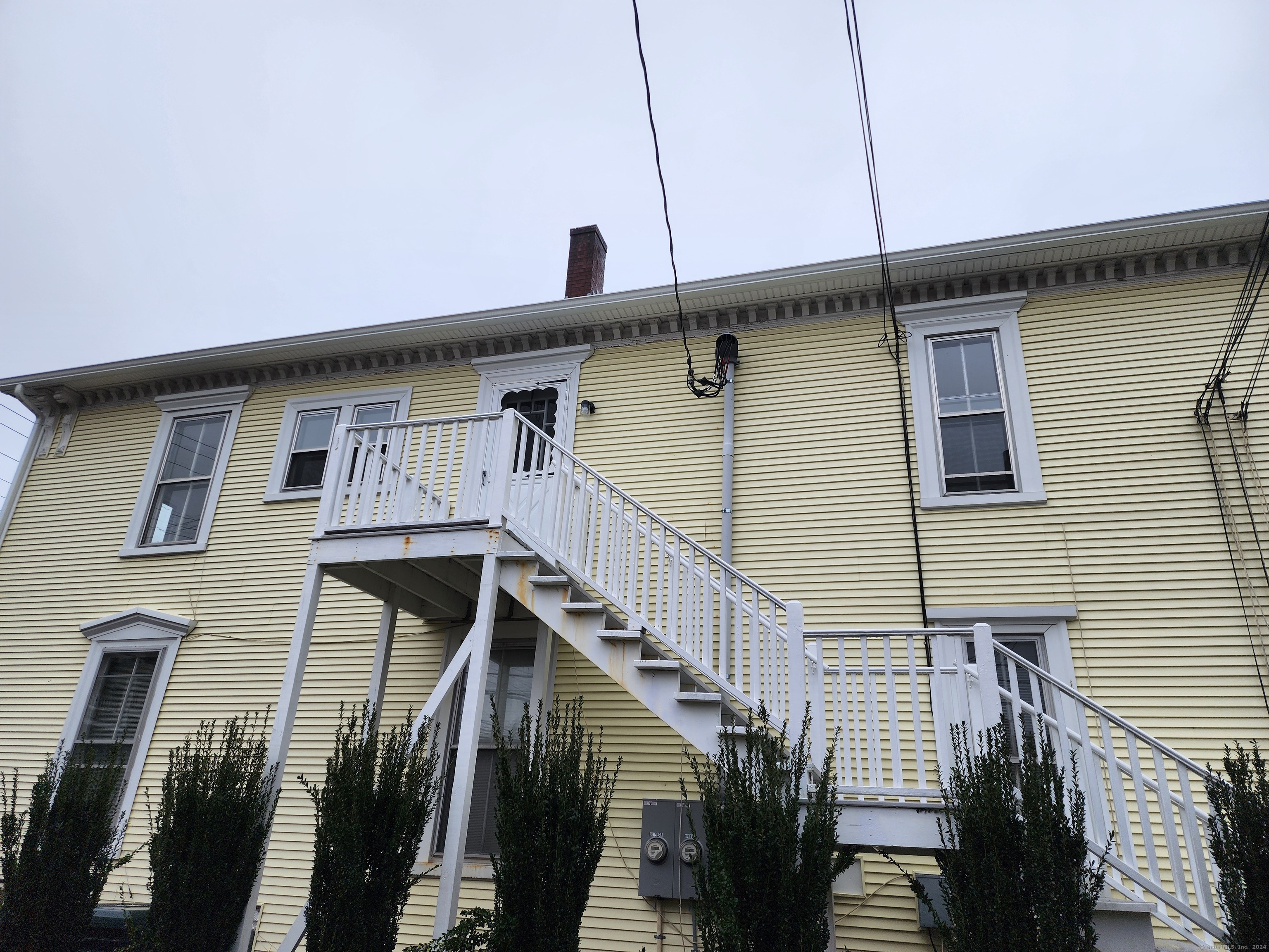 a front view of a house with wooden stairs