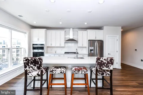 a view of kitchen with cabinets and wooden floor