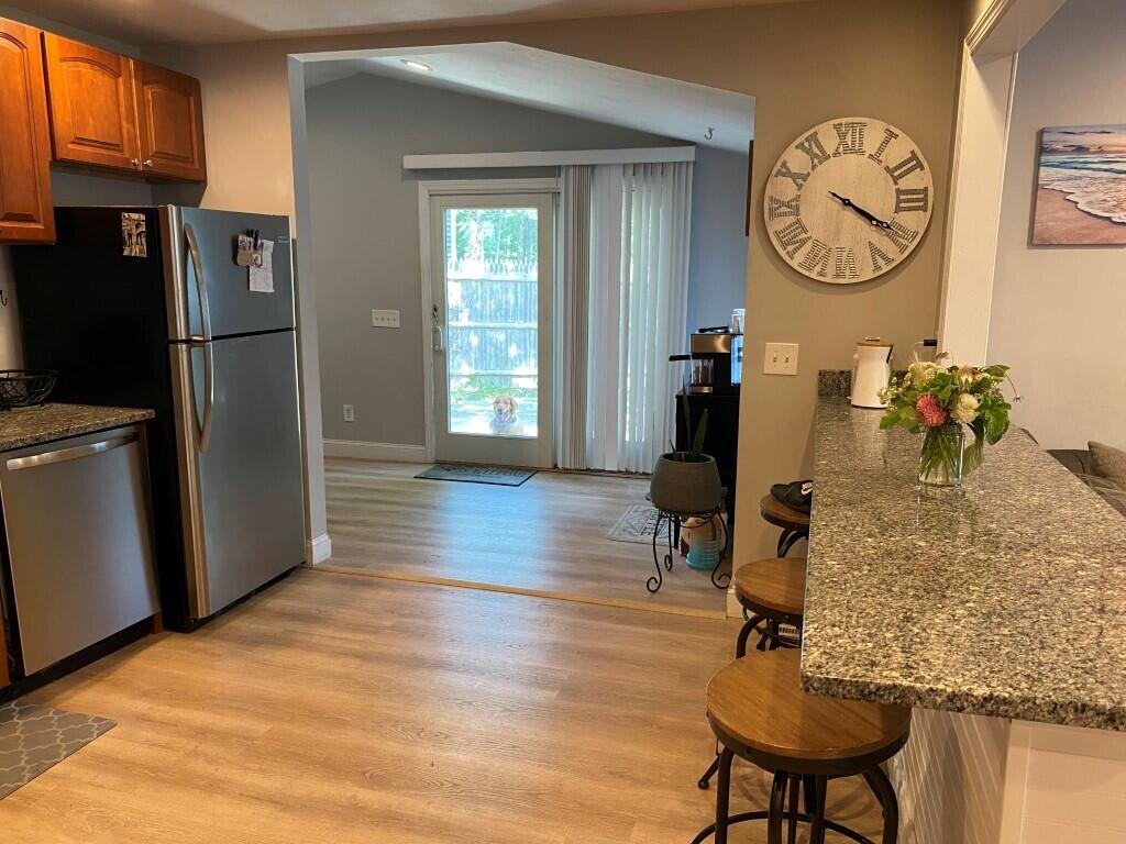 21 Mashpee Neck Road Mashpee, MA 02649 - Photo 12 of 17 a view of a livingroom with furniture wooden floor and a table