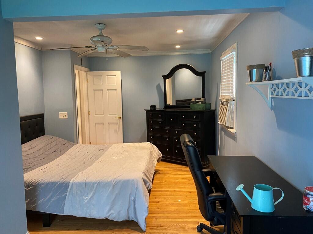 21 Mashpee Neck Road Mashpee, MA 02649 - Photo 15 of 17 a bedroom with a bed and a chandelier