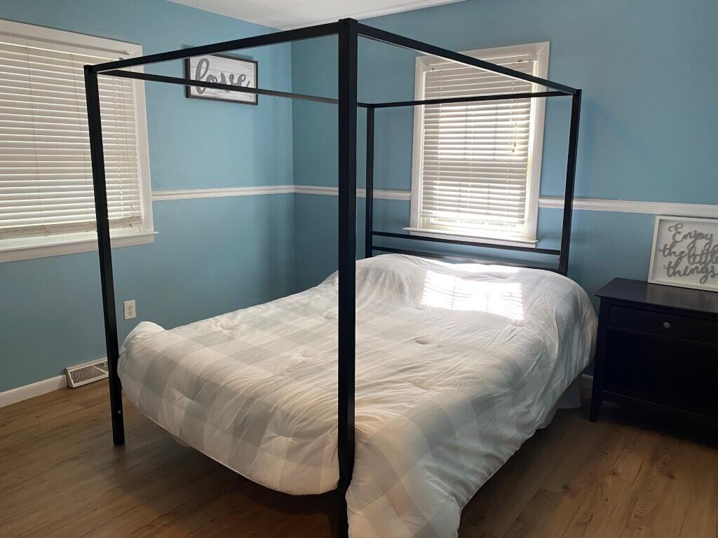 21 Mashpee Neck Road Mashpee, MA 02649 - Photo 16 of 17 a bed sitting in a bedroom next to a window