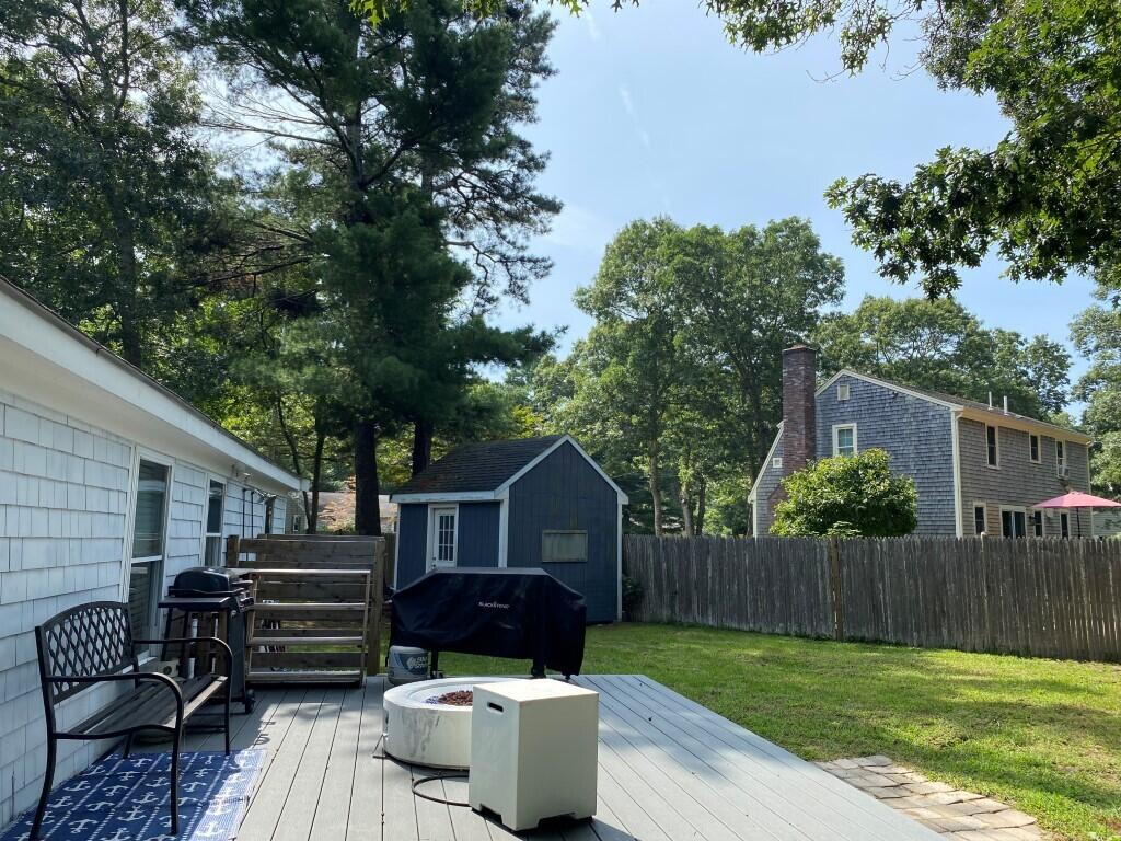 21 Mashpee Neck Road Mashpee, MA 02649 - Photo 3 of 17 a wooden bench sitting in front of a house