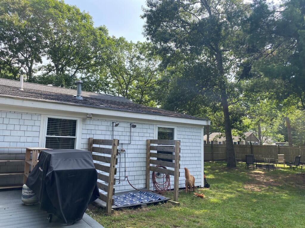 21 Mashpee Neck Road Mashpee, MA 02649 - Photo 4 of 17 a view of a backyard with a large tree