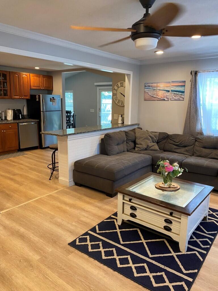 21 Mashpee Neck Road Mashpee, MA 02649 - Photo 9 of 17 a living room with furniture and wooden floor