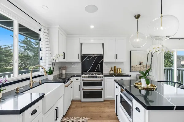 a kitchen that has a sink and a stove in it