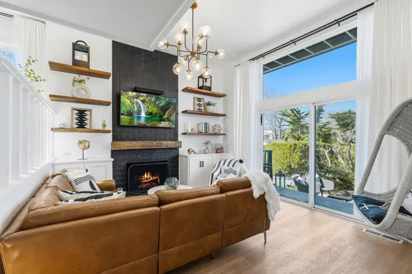 a living room with furniture a fireplace and a flat screen tv