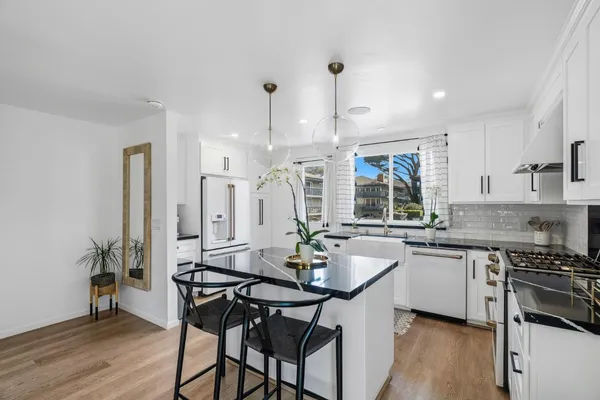 a kitchen with a table chairs stove and cabinets