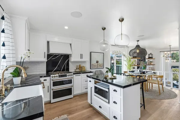 a kitchen with a stove a sink and a refrigerator