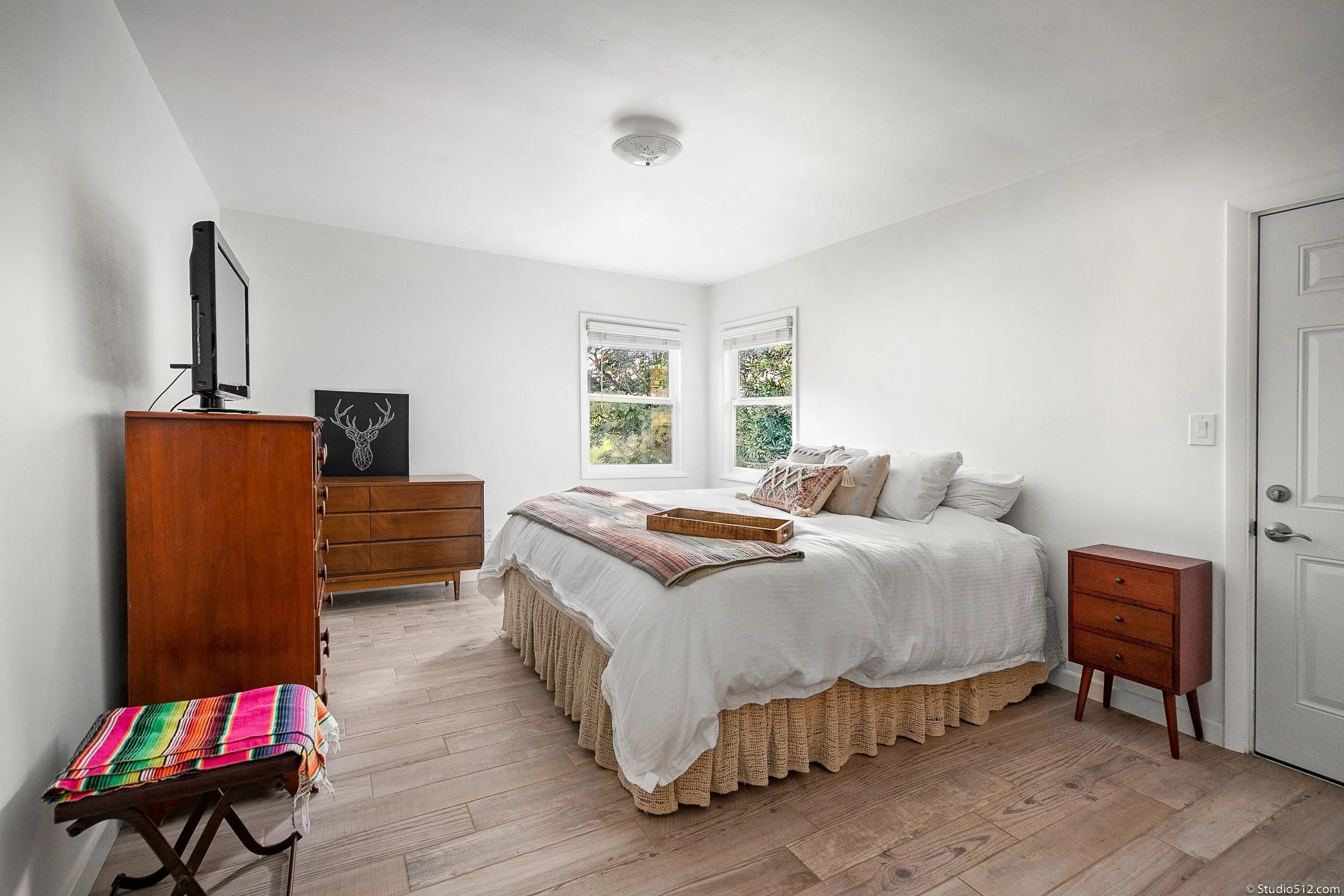 31151 Lilac Road Valley Center, CA 92082 - Photo 11 of 25 a bedroom with a bed and wooden floor