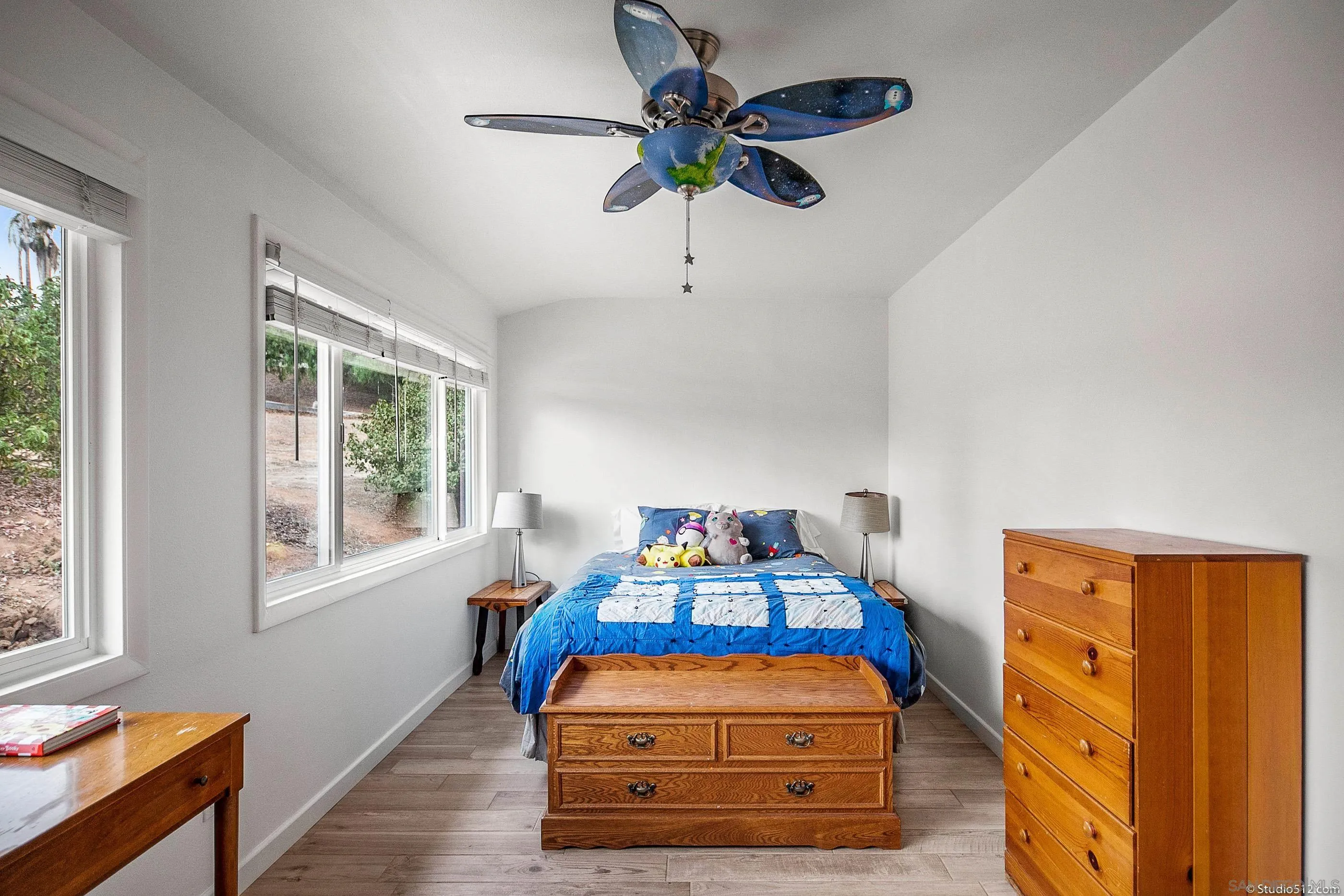 31151 Lilac Road Valley Center, CA 92082 - Photo 16 of 25 a bedroom with a bed and a chandelier