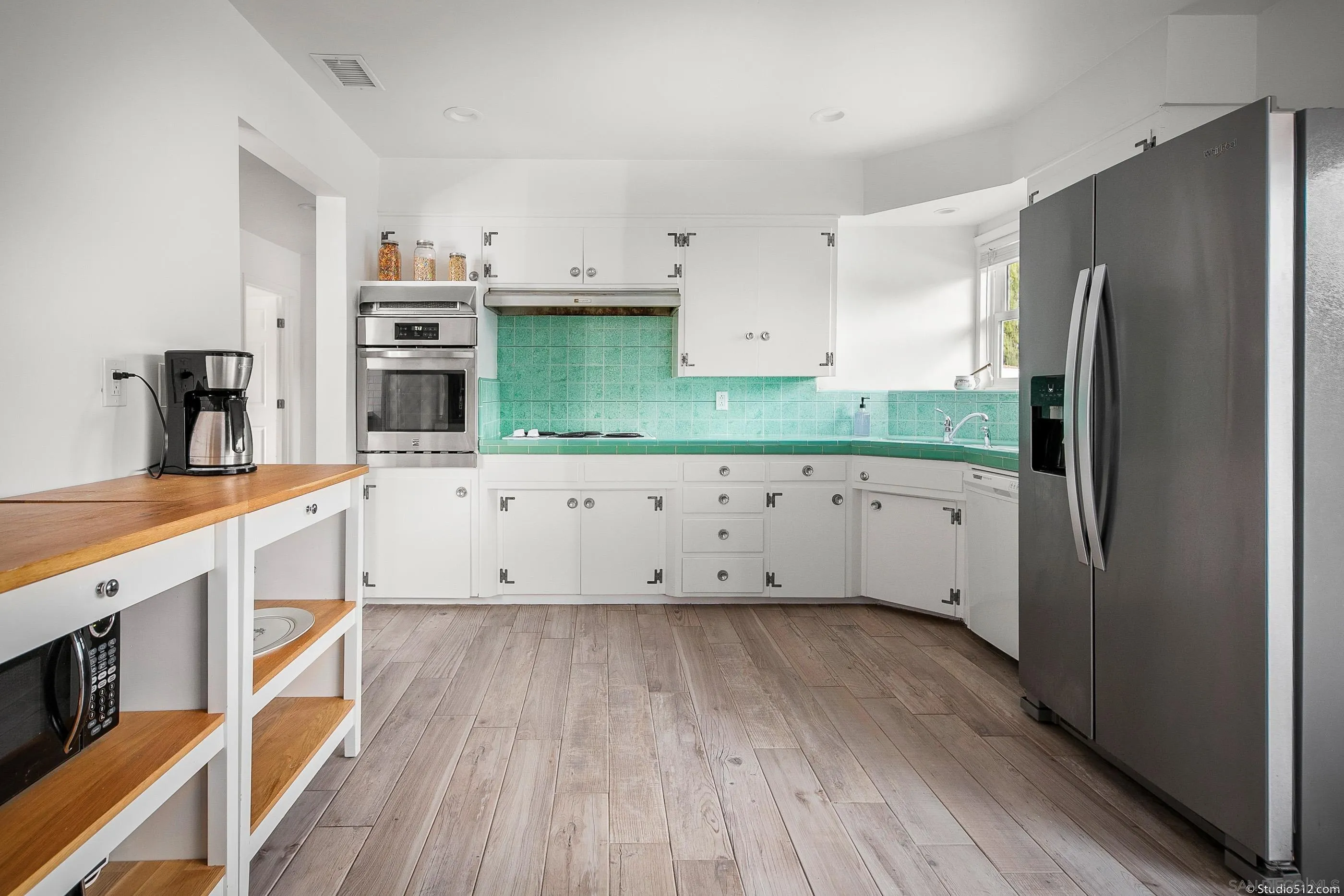 31151 Lilac Road Valley Center, CA 92082 - Photo 9 of 25 a kitchen with stainless steel appliances a refrigerator sink and cabinets