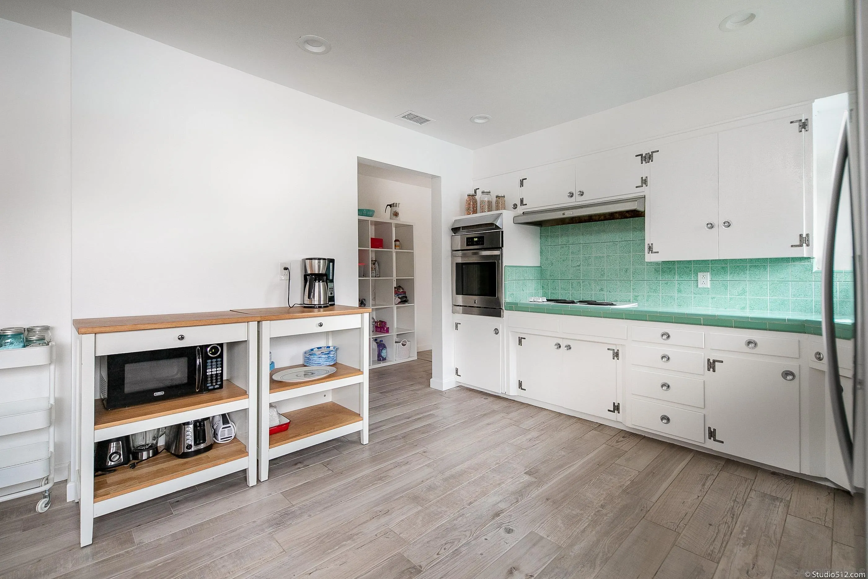 31151 Lilac Road Valley Center, CA 92082 - Photo 10 of 25 a kitchen with stainless steel appliances a stove and white cabinets