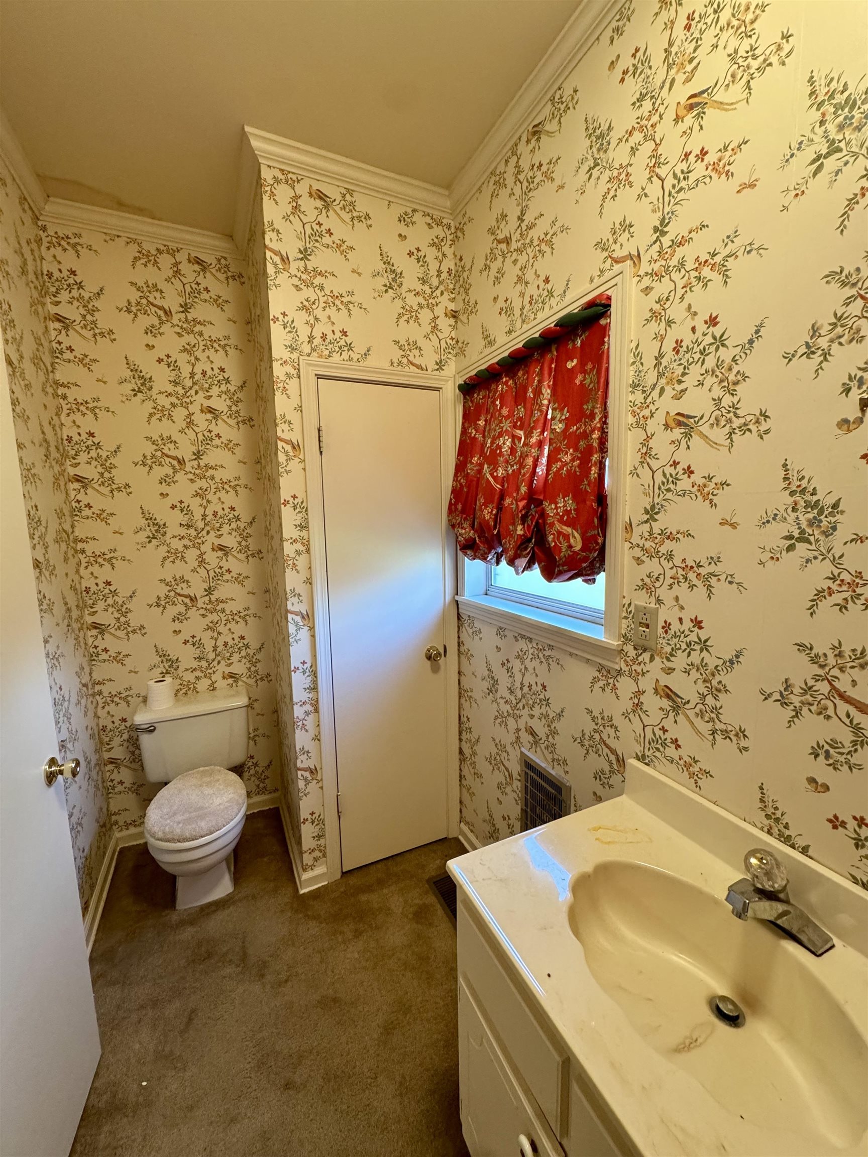 1015 Crestview Street Covington, TN 38019 - Photo 14 of 33 a bathroom with a sink and a toilet