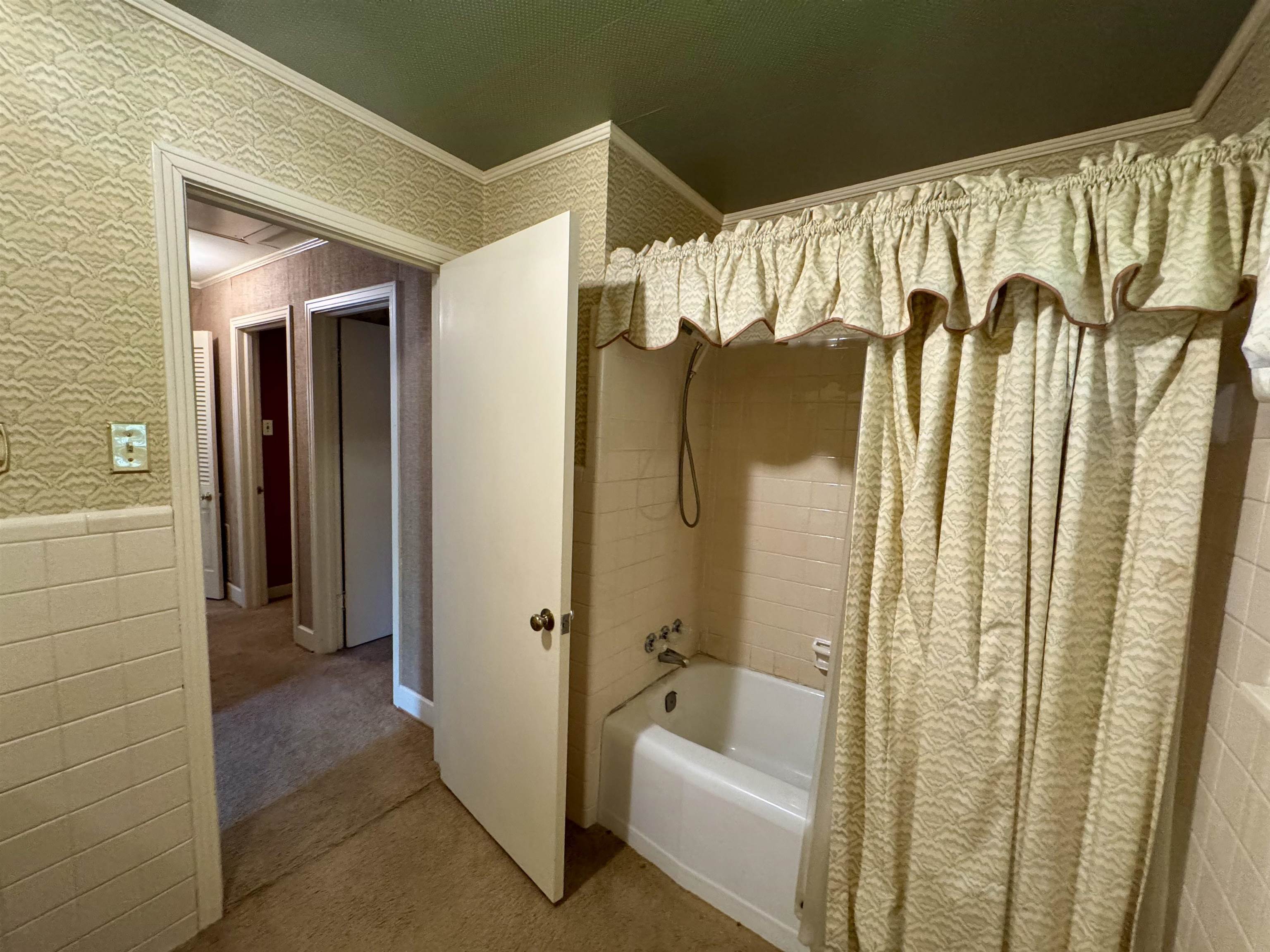 1015 Crestview Street Covington, TN 38019 - Photo 21 of 33 a bathroom with a shower and a tub