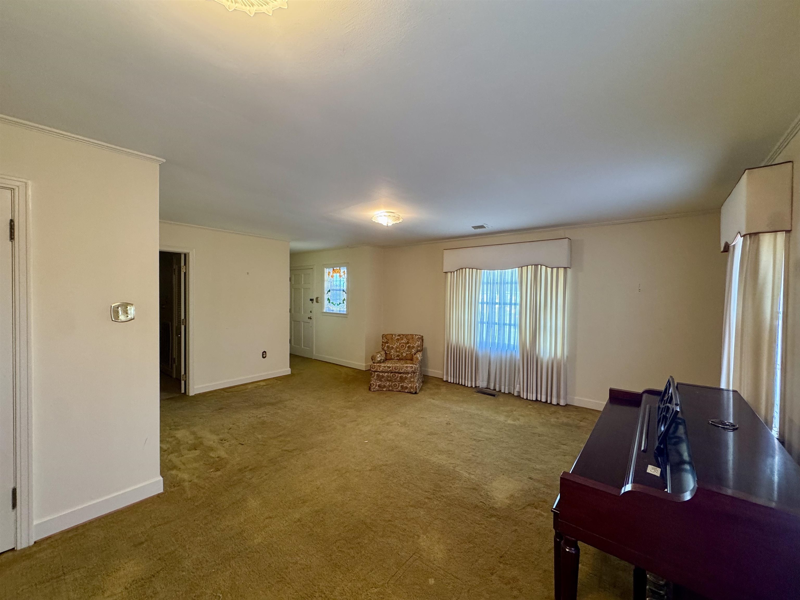 1015 Crestview Street Covington, TN 38019 - Photo 4 of 33 a room with furniture and a window