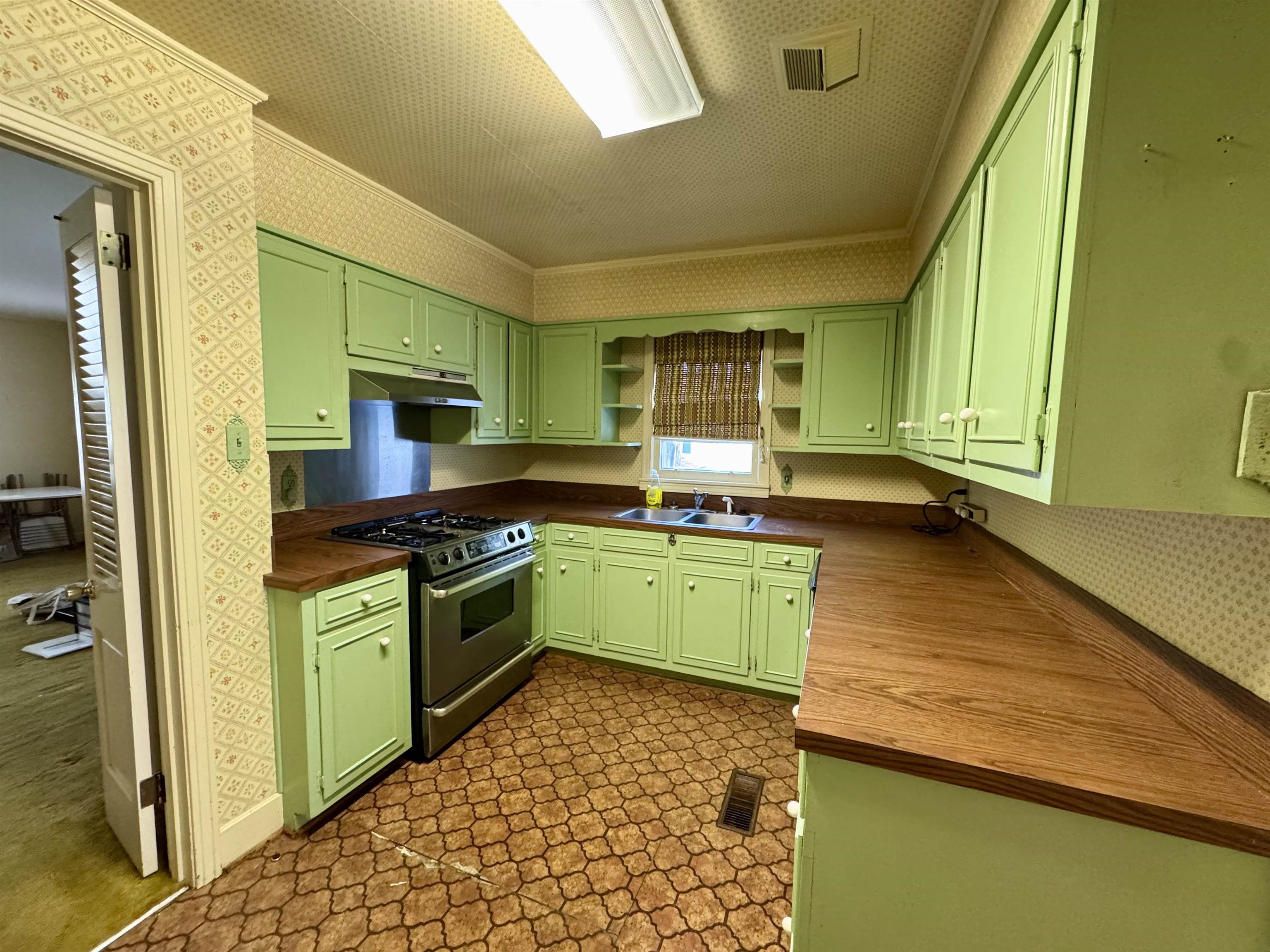 1015 Crestview Street Covington, TN 38019 - Photo 6 of 33 a kitchen with a sink and a stove top oven