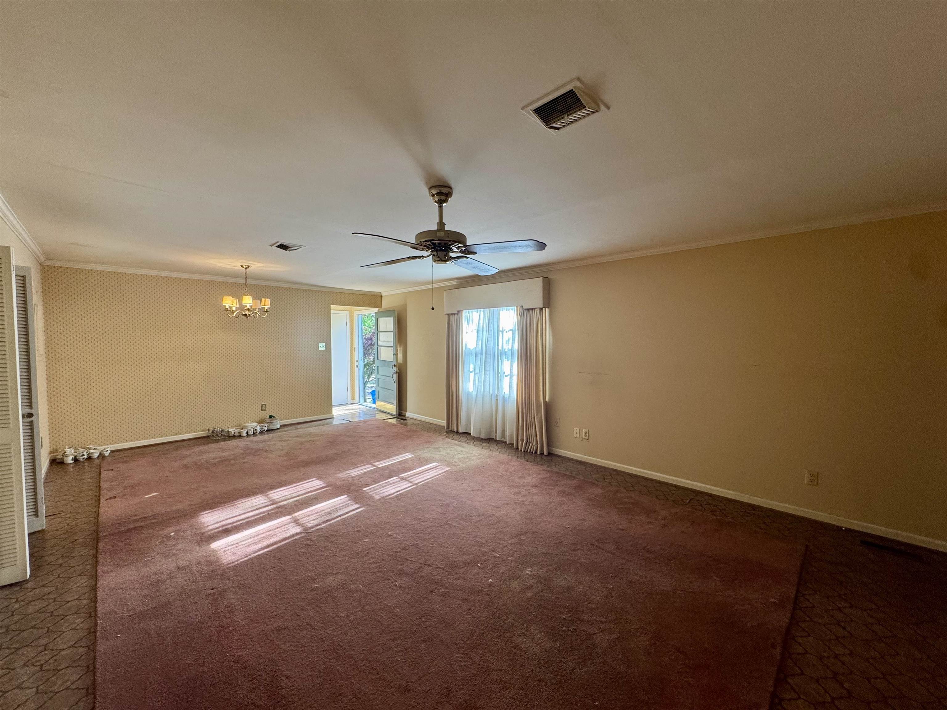 1015 Crestview Street Covington, TN 38019 - Photo 10 of 33 a view of a livingroom with a ceiling fan and window