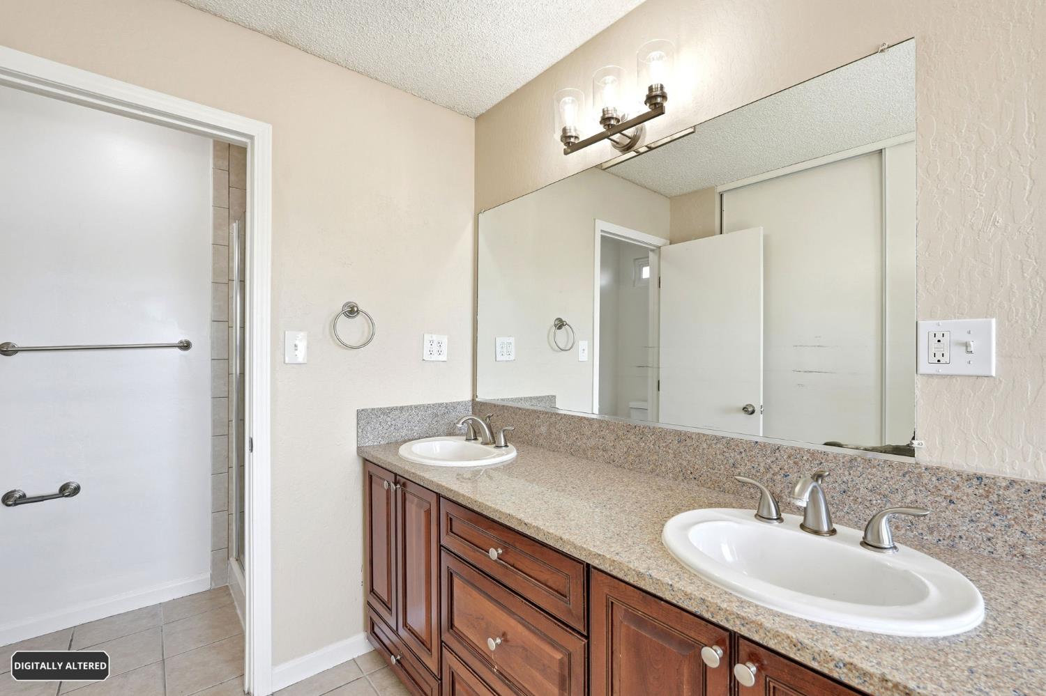 5501 Riverlake Road Discovery Bay, CA 94505 - Photo 36 of 60 a bathroom with a granite countertop sink and a mirror