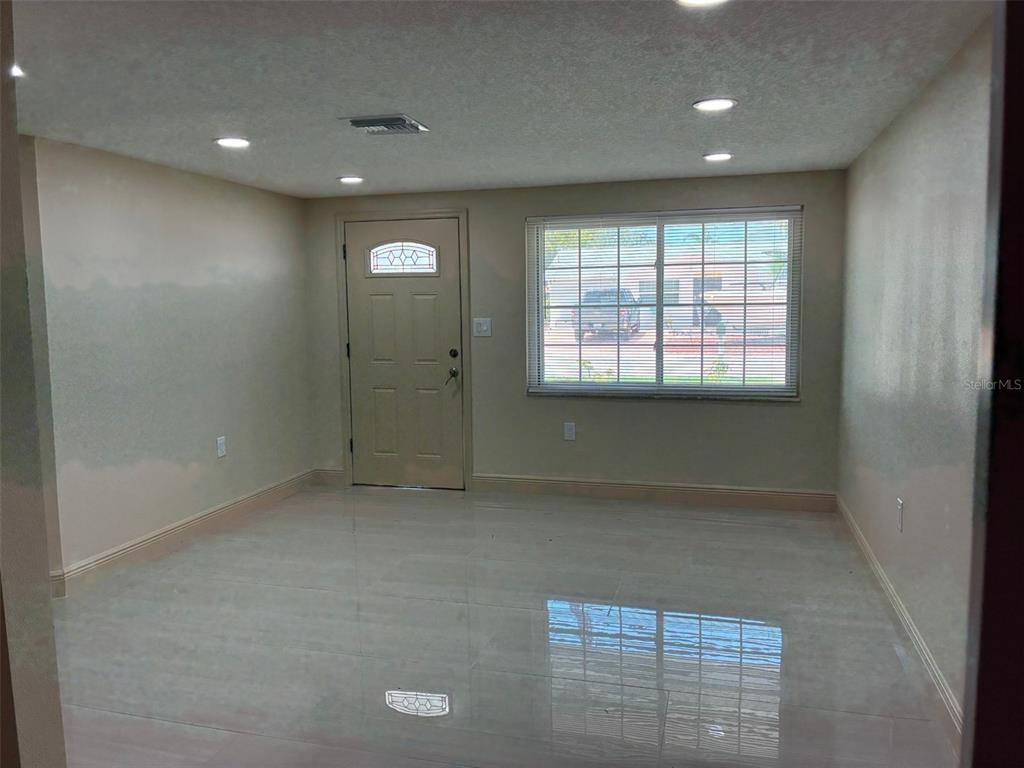 13916 Muriel Avenue Hudson, FL 34667 - Photo 3 of 9 an empty room with windows and closet