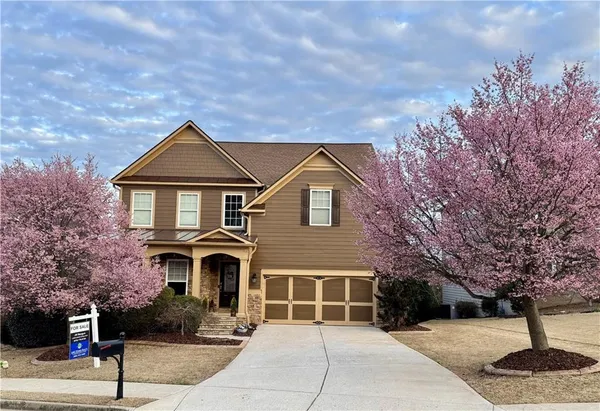 a front view of a house with garden