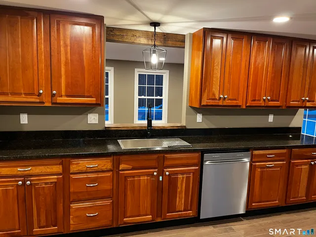 a kitchen with wooden cabinets and a sink