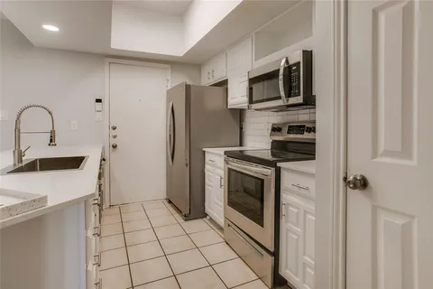 a kitchen with a refrigerator sink and stove
