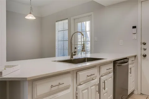 a kitchen with a sink and a refrigerator