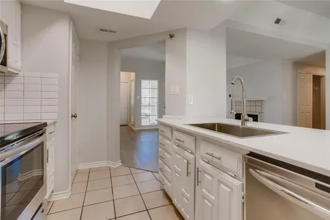 a kitchen with a sink stove and cabinets