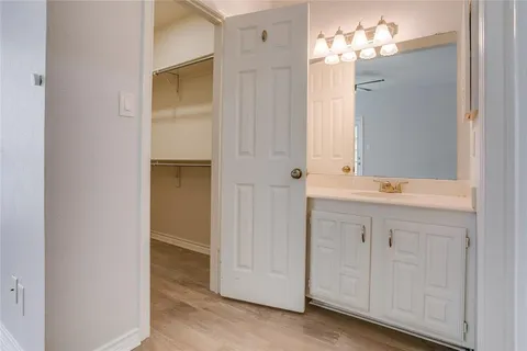 a bathroom with a double vanity sink and a mirror