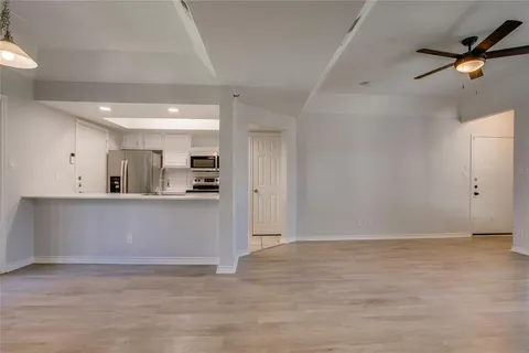 a view of kitchen with stainless steel appliances cabinets