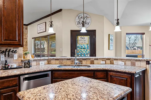 a kitchen with stainless steel appliances granite countertop a sink stove and cabinets