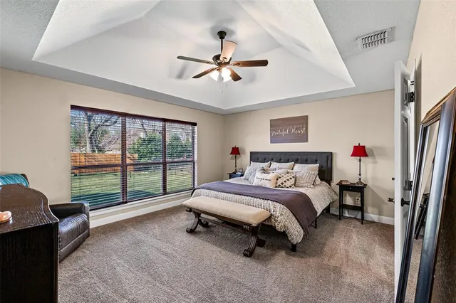 a spacious bedroom with a bed and a chandelier