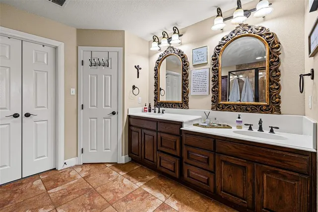 a bathroom with a double vanity sink and a mirror