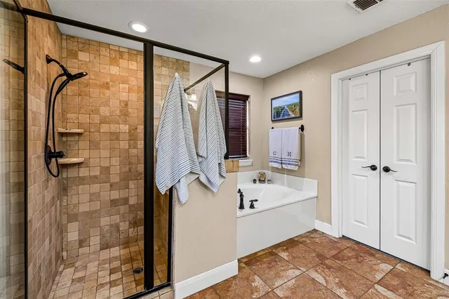 a bathroom with a bathtub and a shower