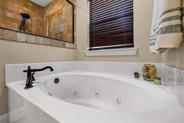 a bathroom with a tub sink and a mirror