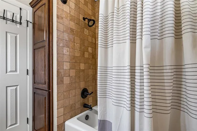 a bathroom with a bathtub and shower