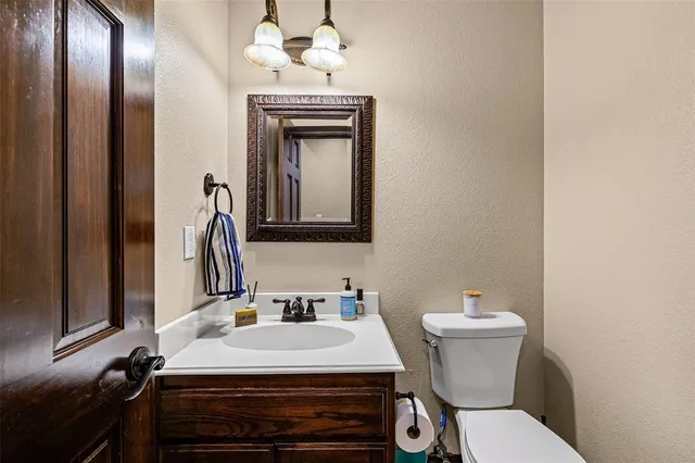 a bathroom with a sink toilet and mirror