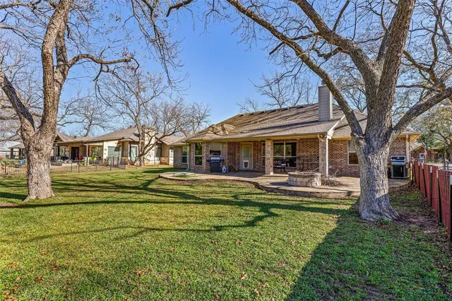 a front view of a house with swimming pool having outdoor seating