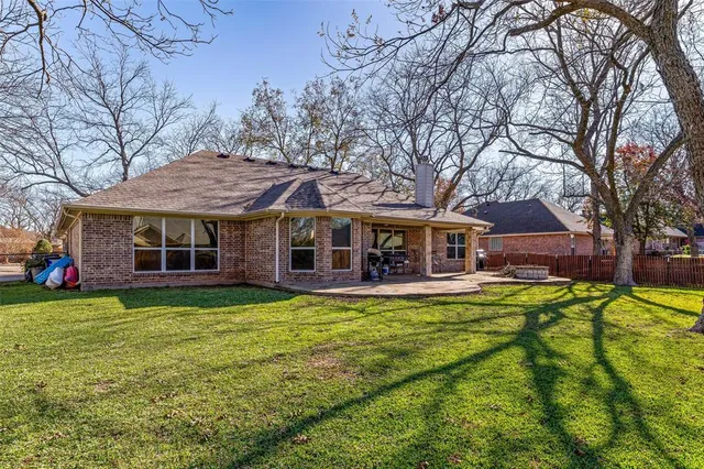 a view of a house with pool and a yard