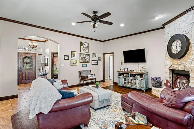 a living room with furniture a flat screen tv and a fireplace