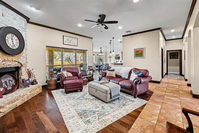 a living room with furniture a large window and a fireplace