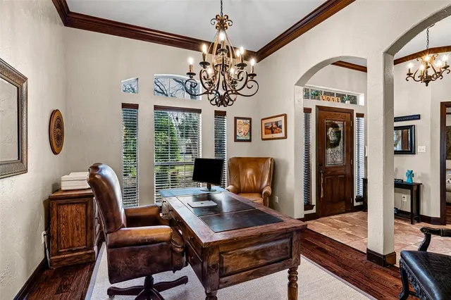 a view of a dining room with furniture wooden floor and chandelier