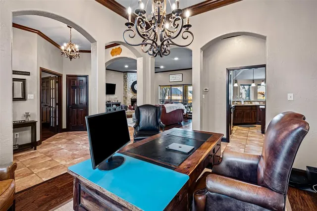 a living room with furniture a chandelier and a dining table