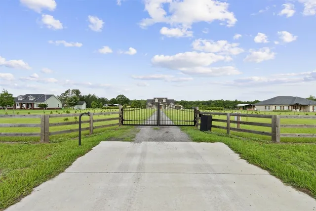 a view of a big yard with lots of green space