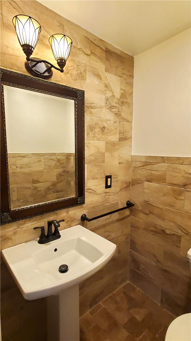988 Hoch Road Danielsville, PA 18038 - Photo 21 of 29 Elegant pedestal sink and decorative mirror create a refined powder room.