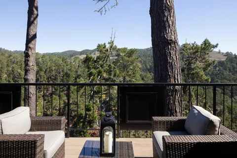 a view of a balcony with couches and wooden floor